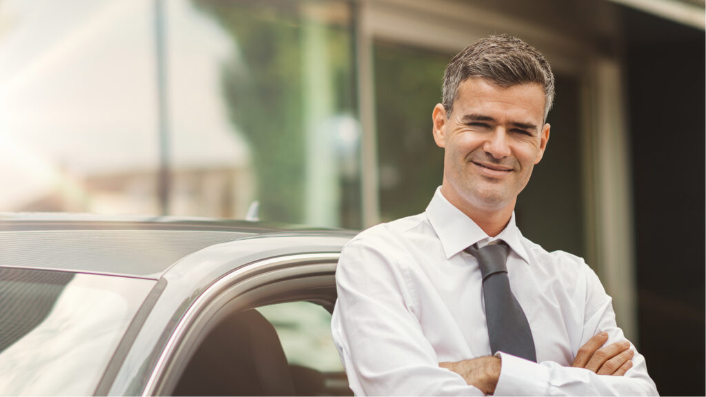 Salesman in front of car