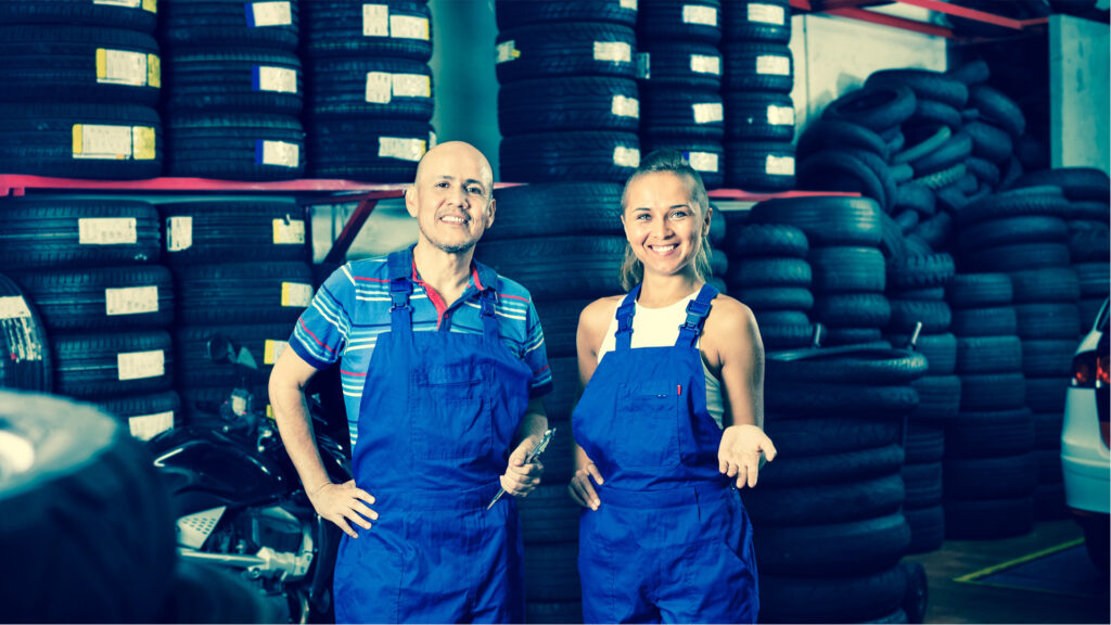 Two techs in front of tires
