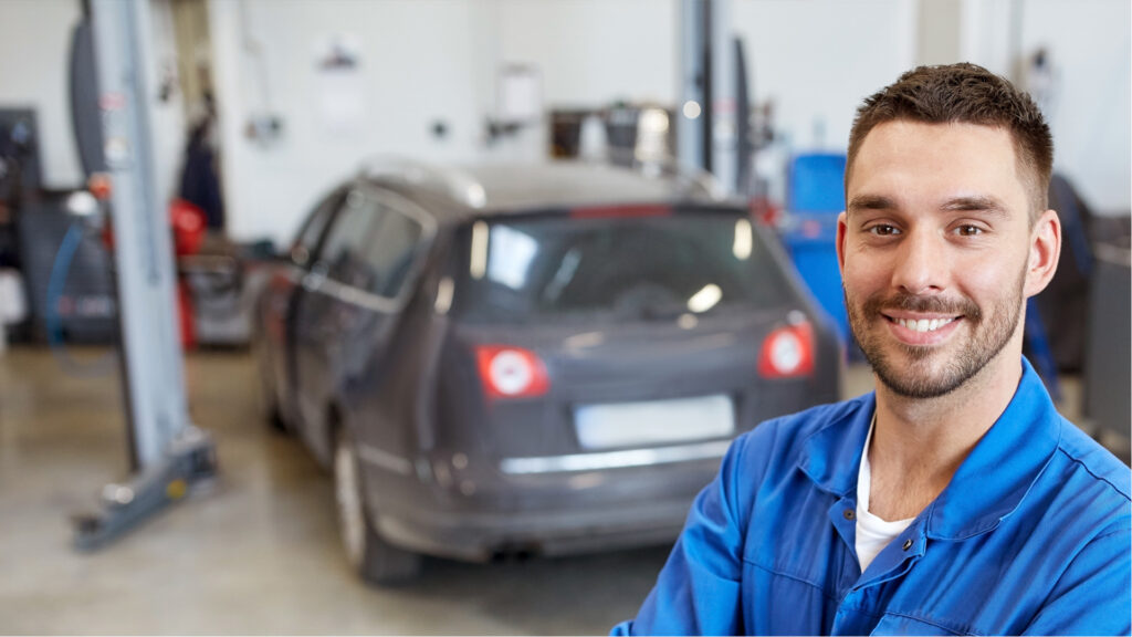 Mechanic standing in front of car