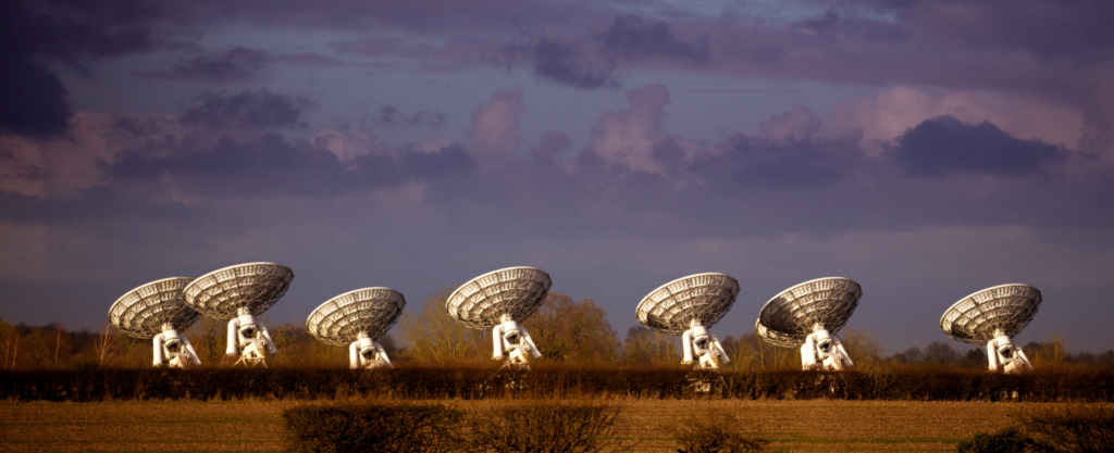 Satellites communicating with car dealership GPS trackers.