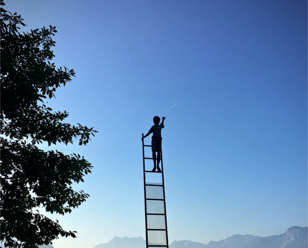 A child moving up the ladder to reach a shooting star.