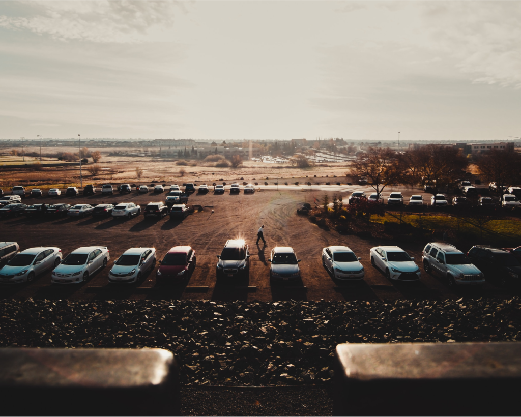 A salesperson walks past vehicles learning how to sell more cars.