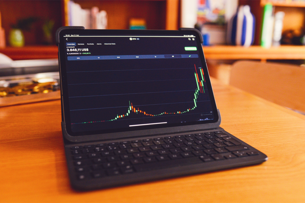 A laptop displaying a graph of auto dealer profits.