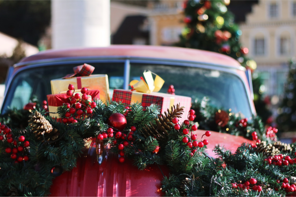 Holiday marketing campaigns for dealerships represented by presents on a car hood.