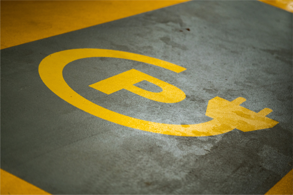 EV sales challenges represented by an EV charging parking spot.