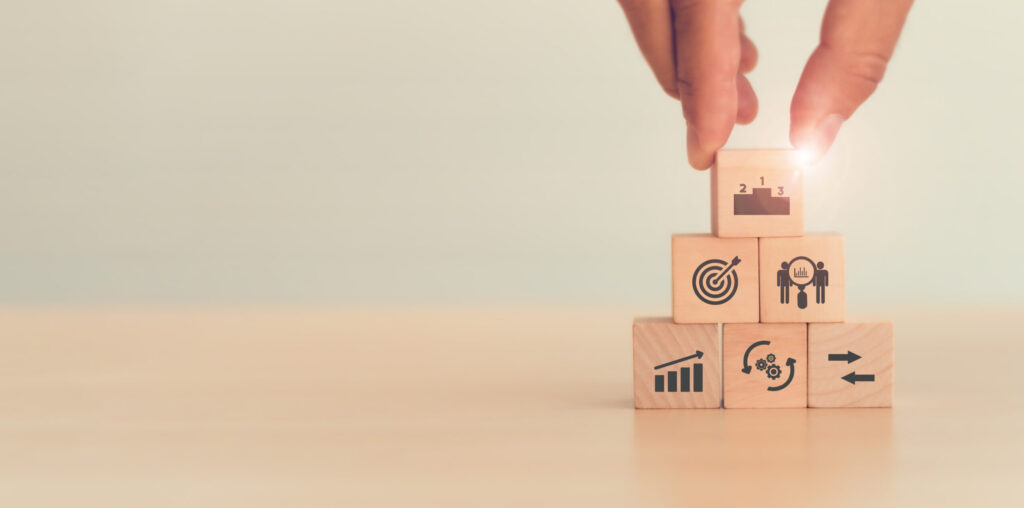 Benchmarking for auto dealers represented by building blocks with metric symbols.