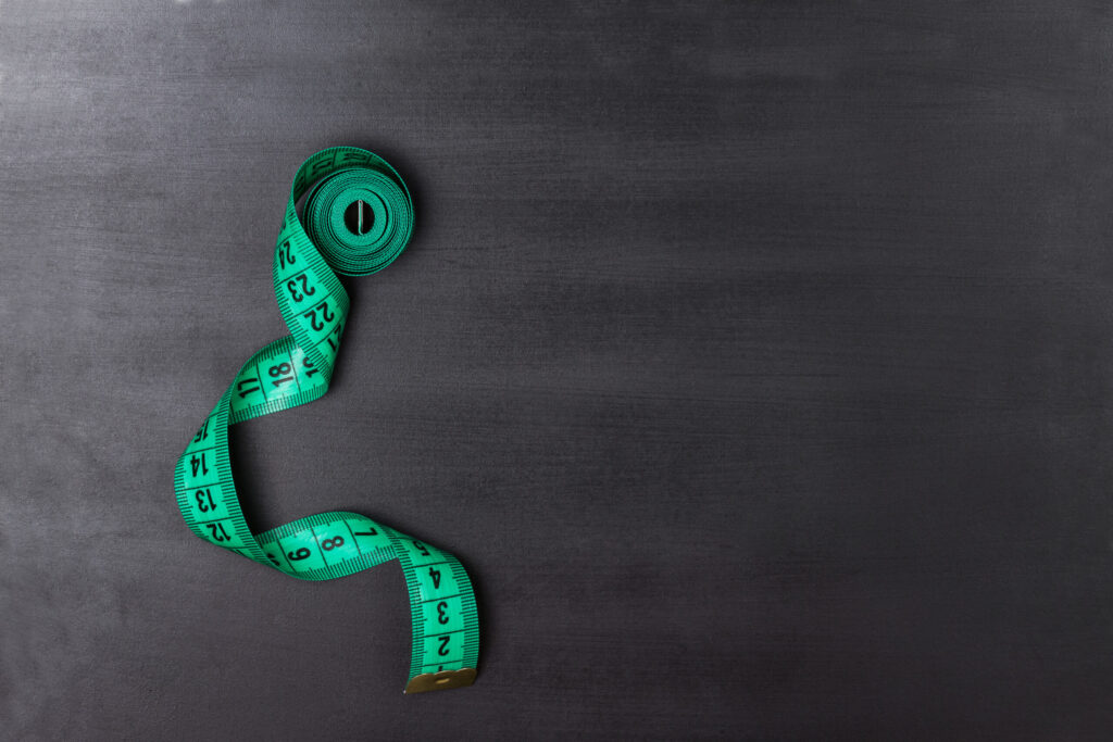 A tape measure represents key metrics in the auto industry.