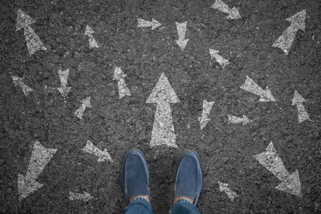 A person choosing a direction to walk represents the automotive customer journey.