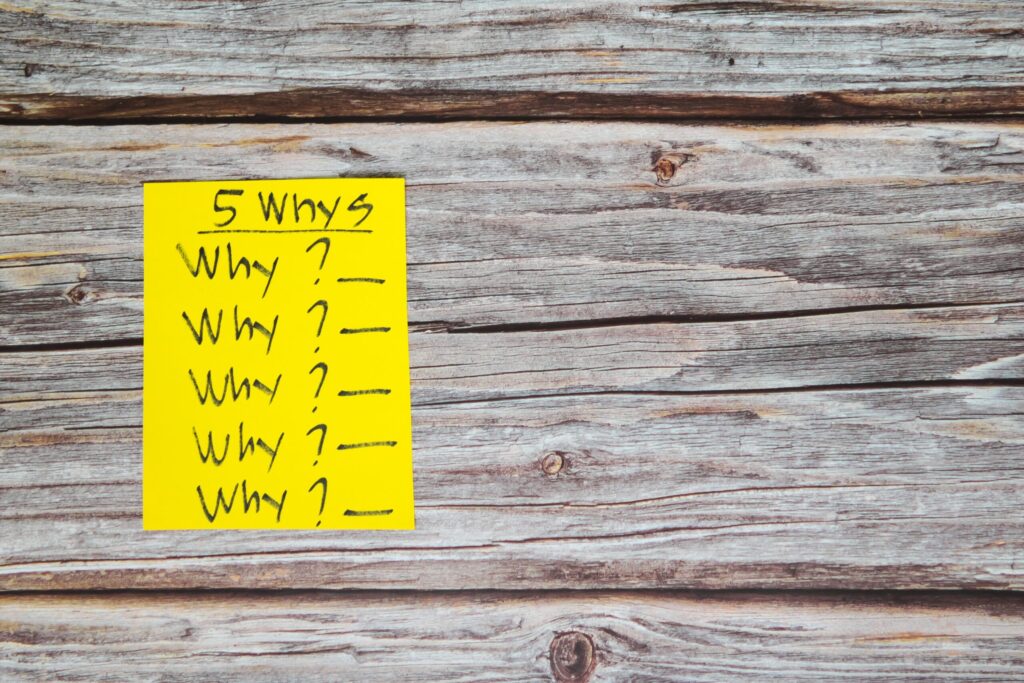 5 Whys root cause analysis written on a sticky note.